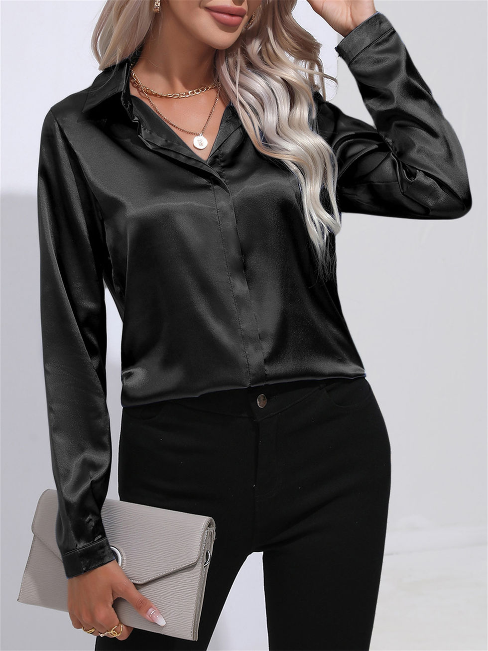 Thumbnail: Woman wearing a long-sleeve black satin button-down shirt
