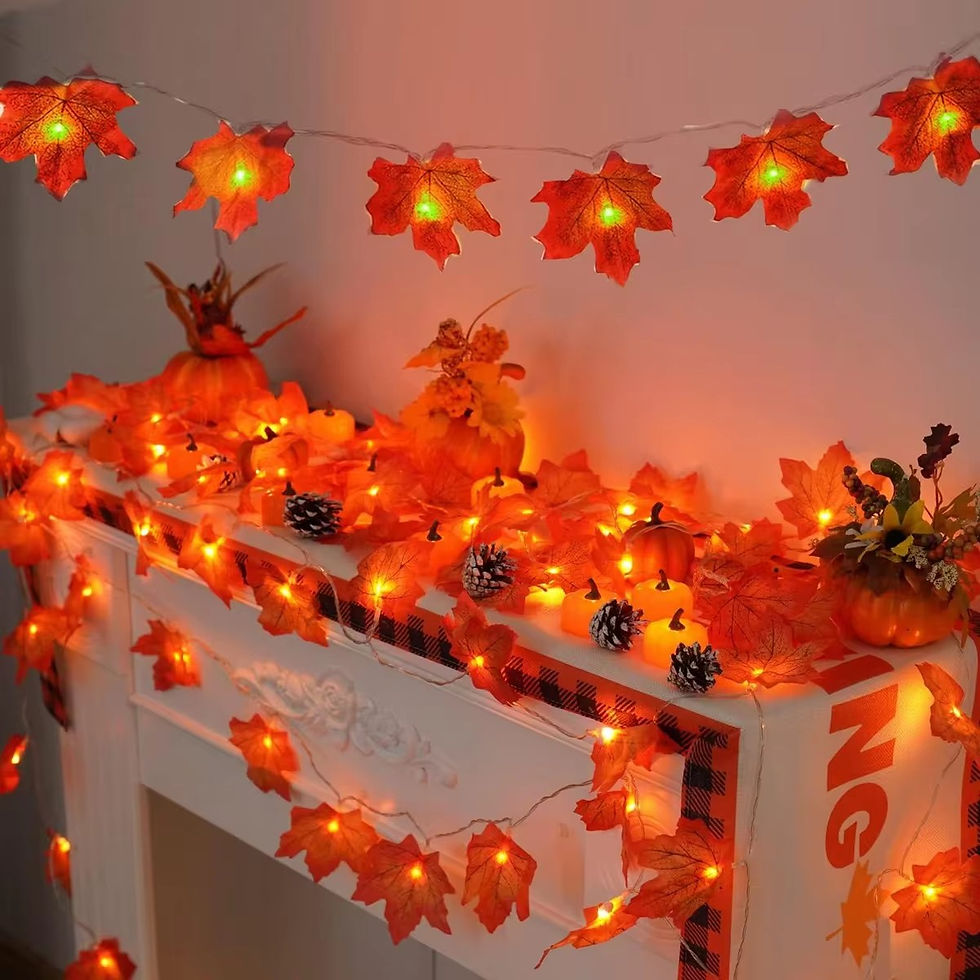 Thumbnail: Halloween maple leaves string lights on a white fireplace