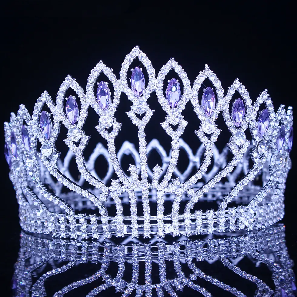 Elegant silver rhinestone pageant crown displayed on black reflective surface.