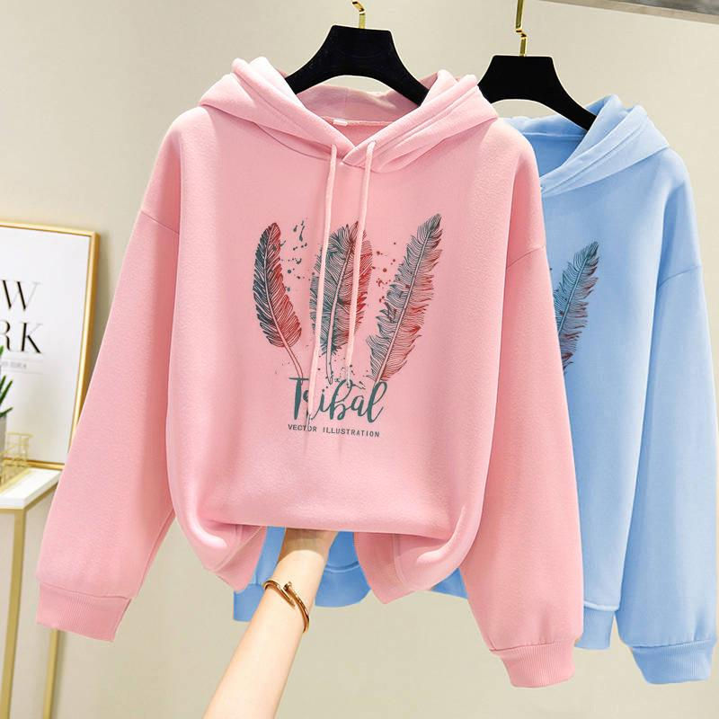 Pink and blue hoodies with feather graphic on hangers
