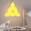 Thumbnail: Bright yellow Smart RGB Wall Lamp – Modular Triangle Light Panels on bedroom wall.