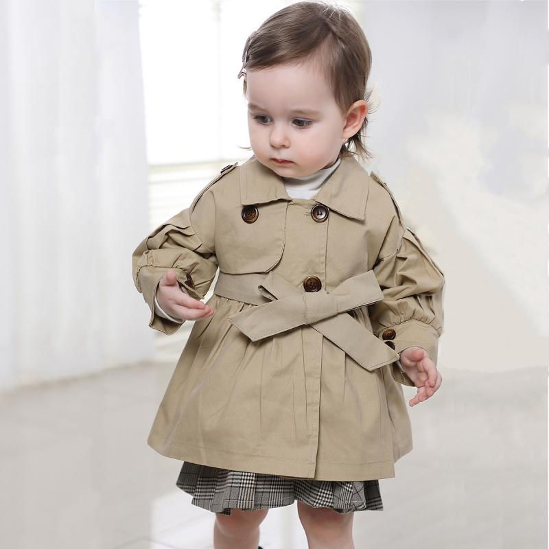 Thumbnail: Toddler wearing a beige cotton jacket with a belted waist