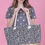 Thumbnail: Woman holding a tote bag with leopard print; star shirt; pink backdrop.