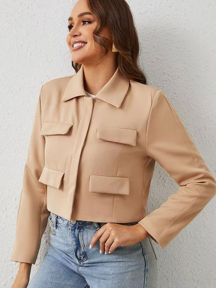 Thumbnail: Woman wearing a beige cropped utility jacket with pockets.