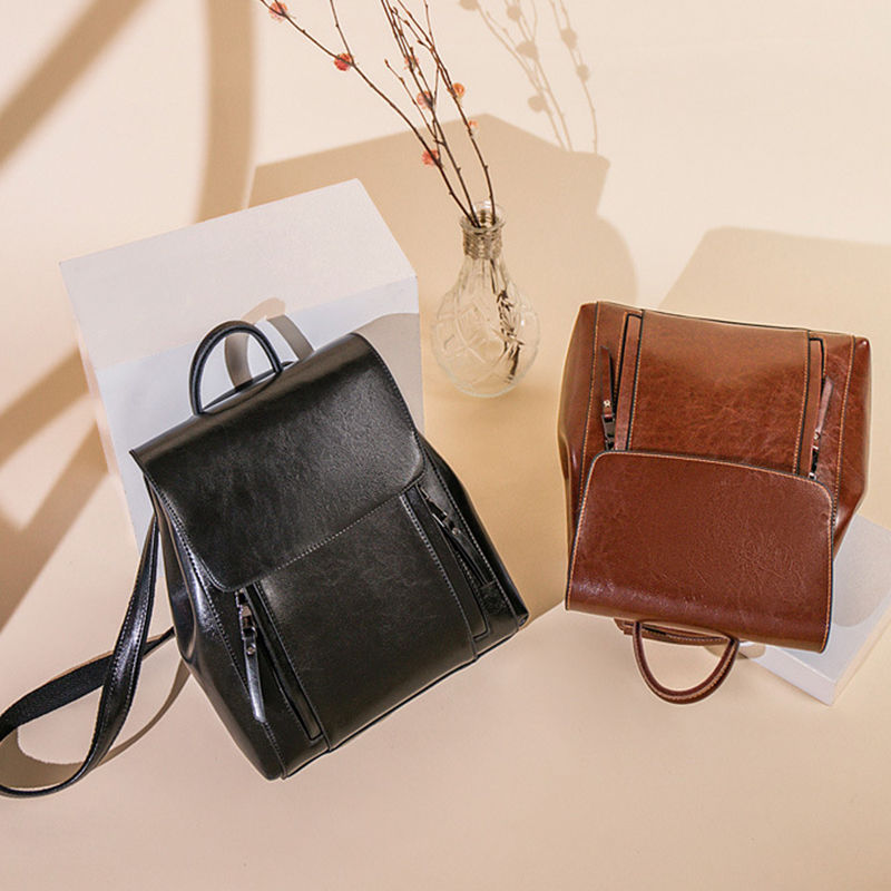 Black and brown small leather backpacks on display.