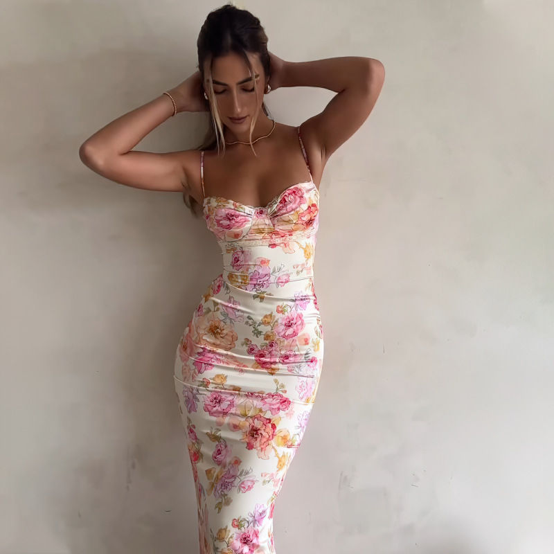 Thumbnail: Woman posing in a floral print bodycon maxi dress.