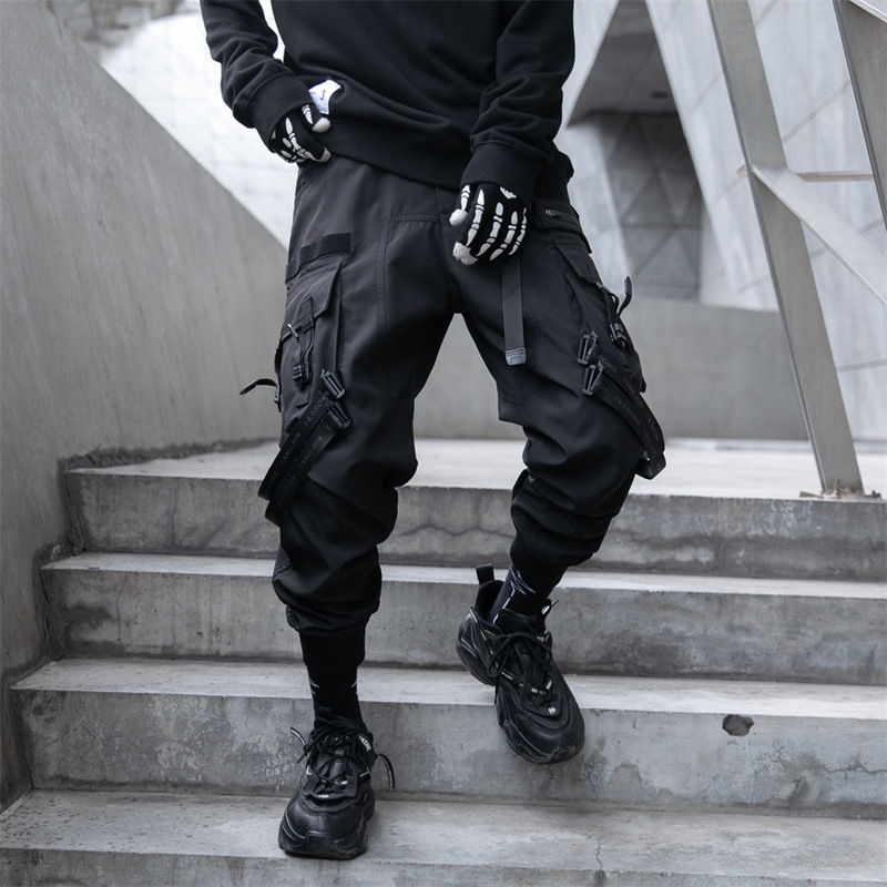 Black multi-pocket tactical techwear cargo pants on a model