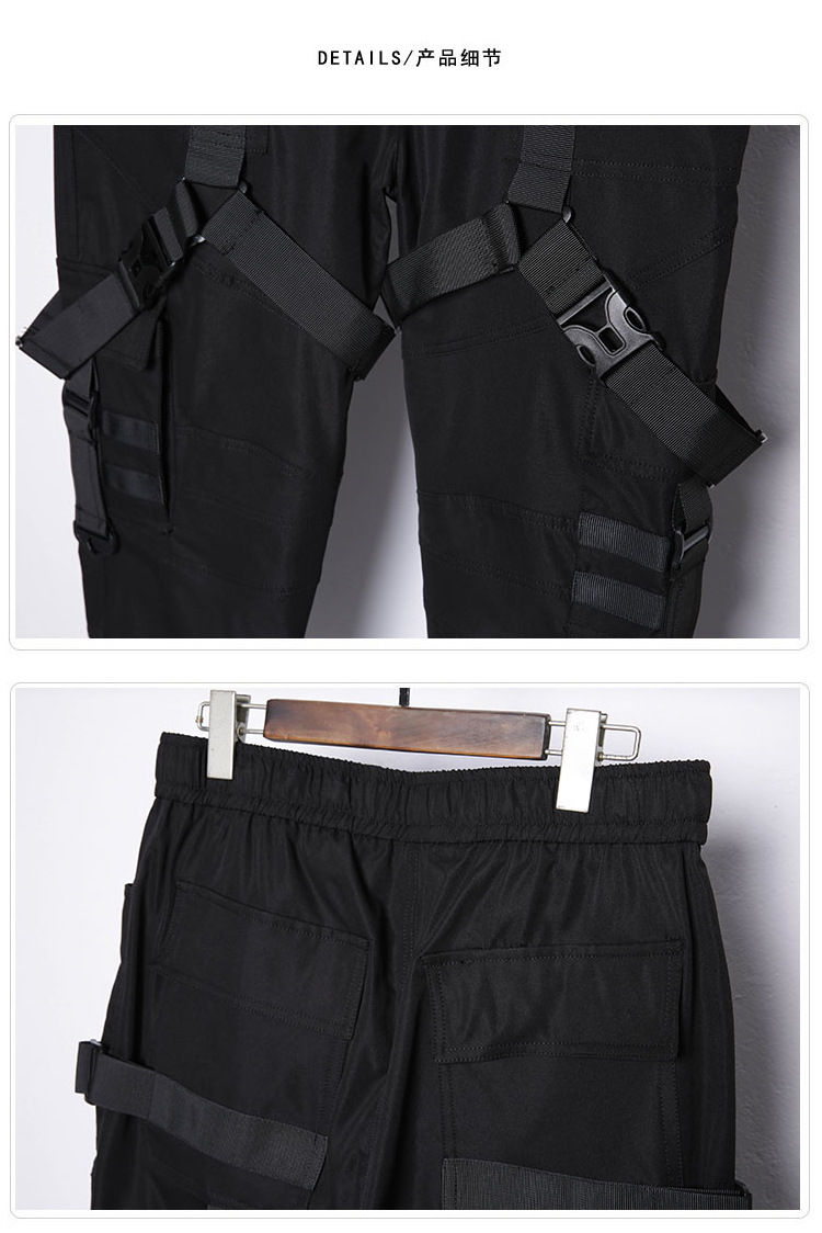 Thumbnail: Black techwear cargo pants with multi-ribbon straps.