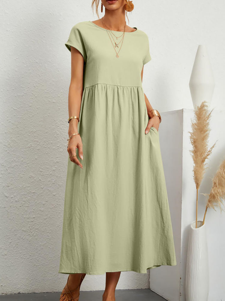 Woman wearing a light green short-sleeve maxi dress