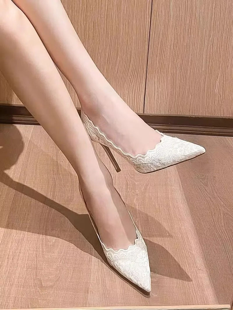 Thumbnail: White lace pointed tip high heels on a woman's feet