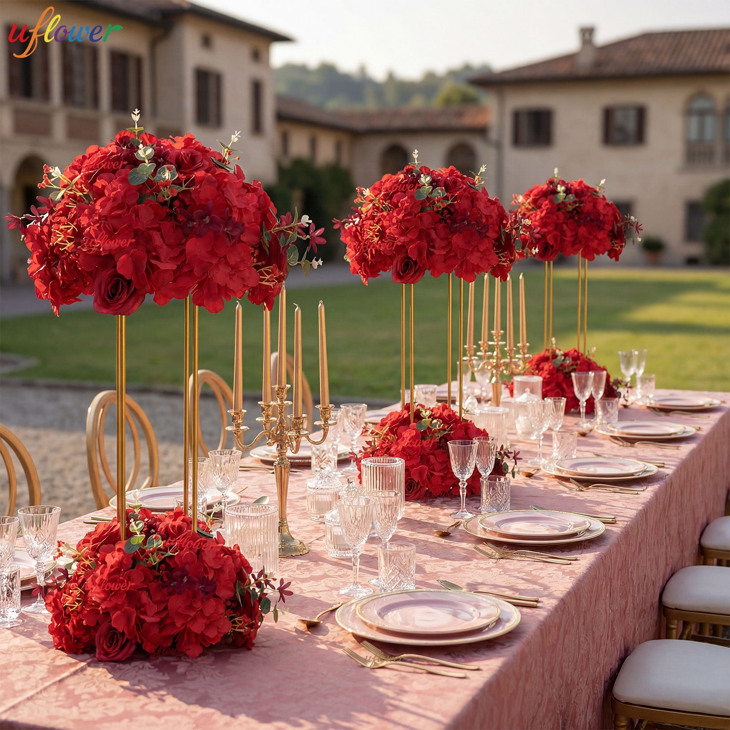 Red silk rose flower ball bouquets on gold stands for weddings