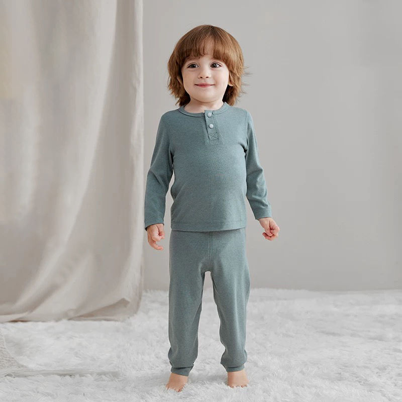 Thumbnail: Toddler boy wearing a teal ribbed long-sleeve pajama set.
