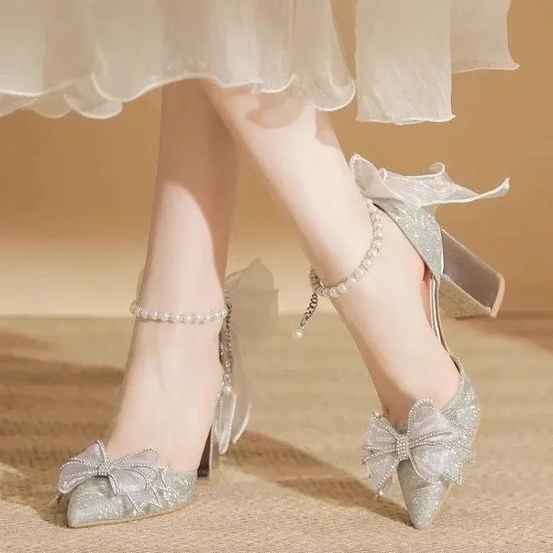 Silver high heel sandals with bows and pearl ankle straps