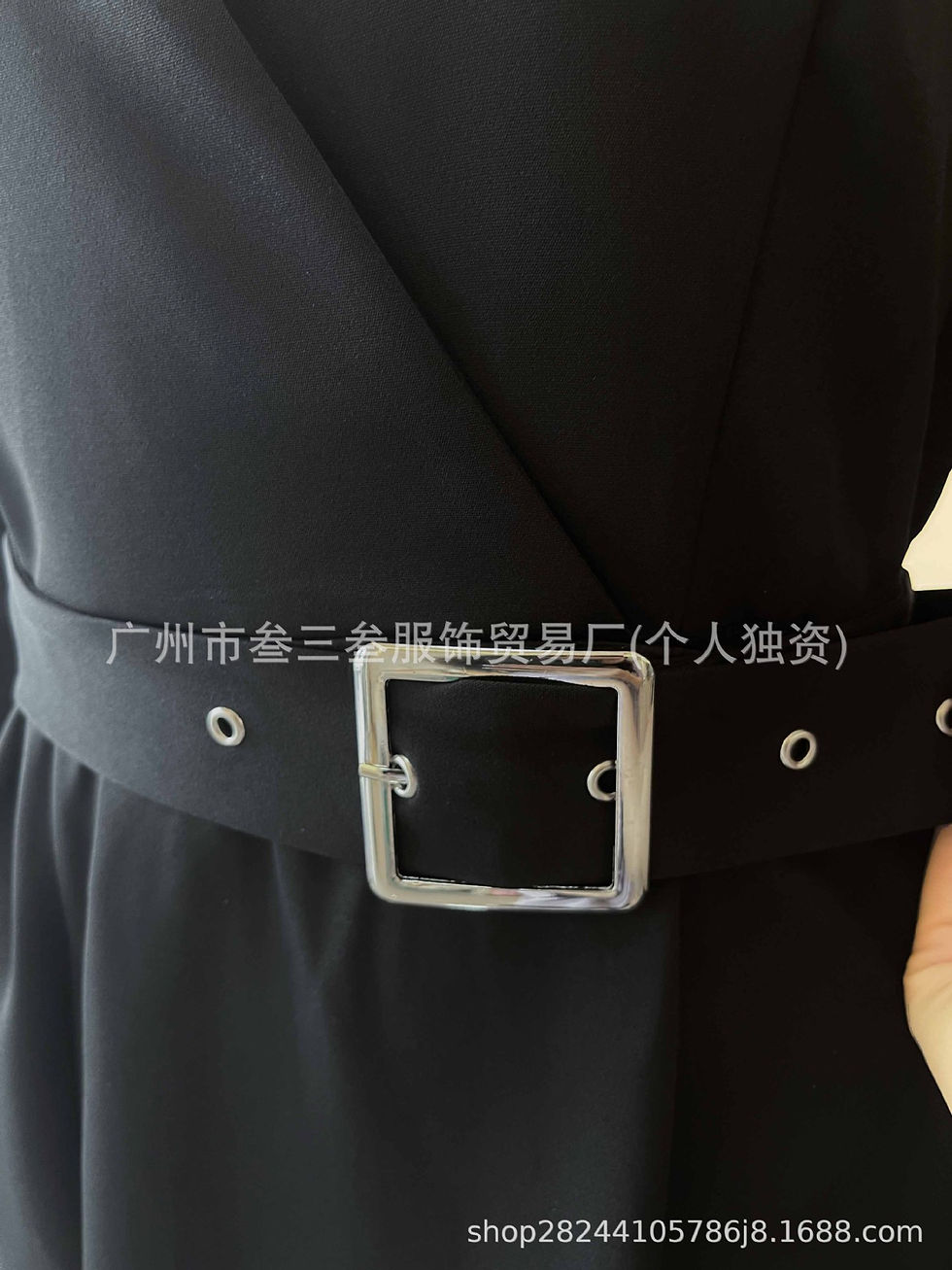Thumbnail: Close-up of black long-sleeved dress with silver buckle belt