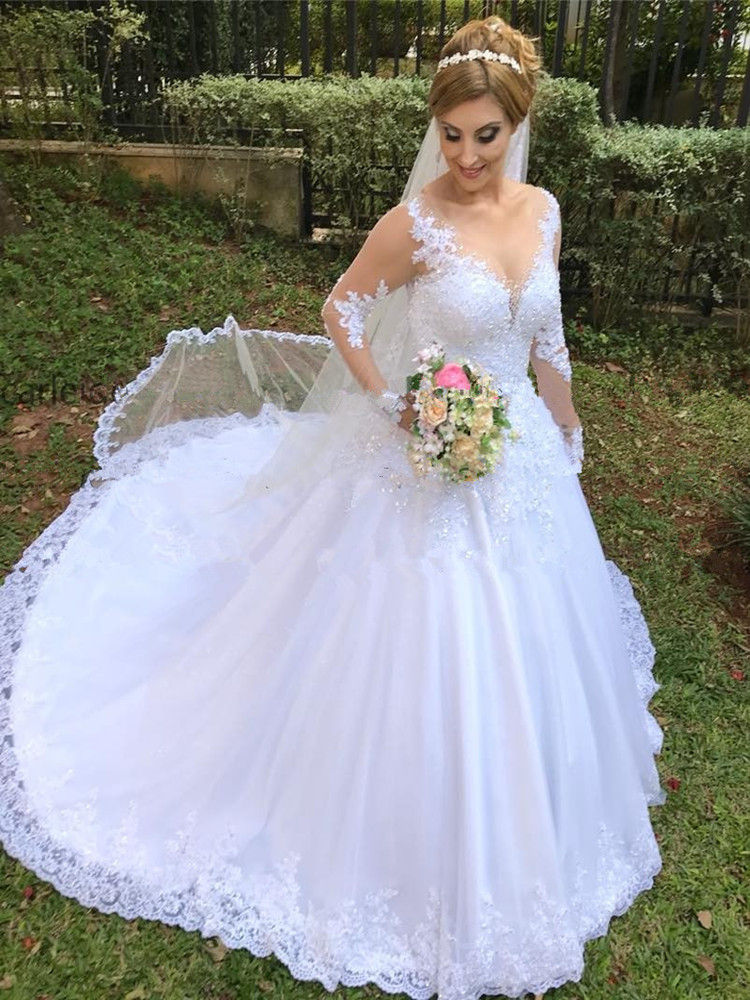 Thumbnail: Bride in a bohemian lace wedding dress with long sleeves