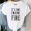 Thumbnail: White t-shirt with text: It's Fine I'm Fine Everything's Fine. Adine