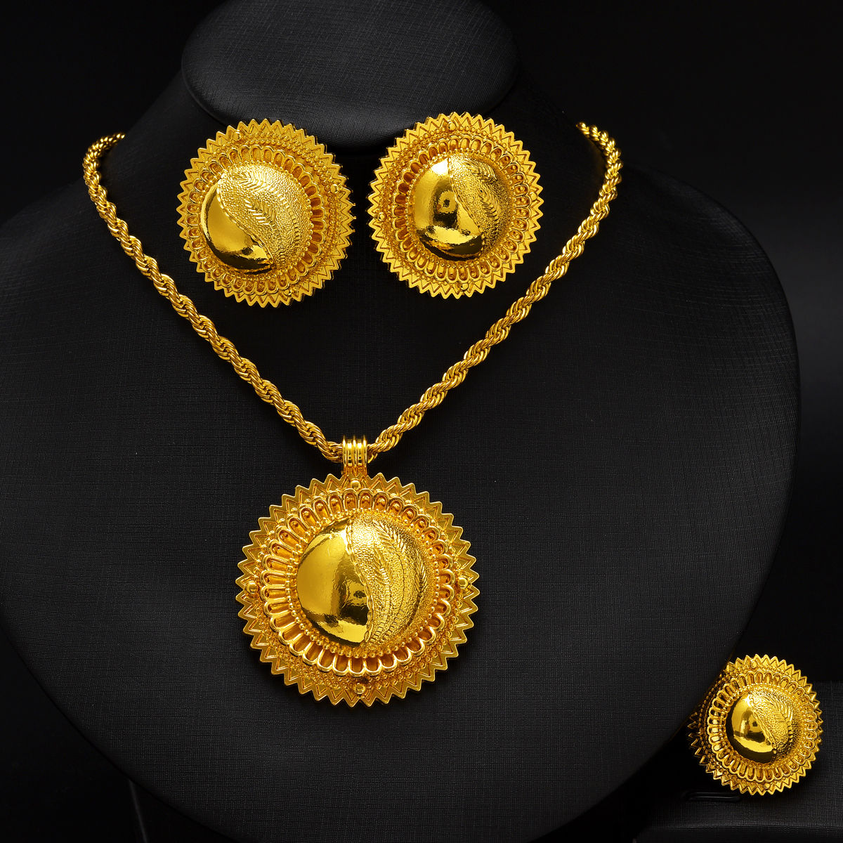 Eritrean gold jewelry set with pendant, earrings, and ring