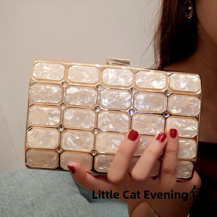 Thumbnail: Elegant white acrylic square clutch bag held by a person.