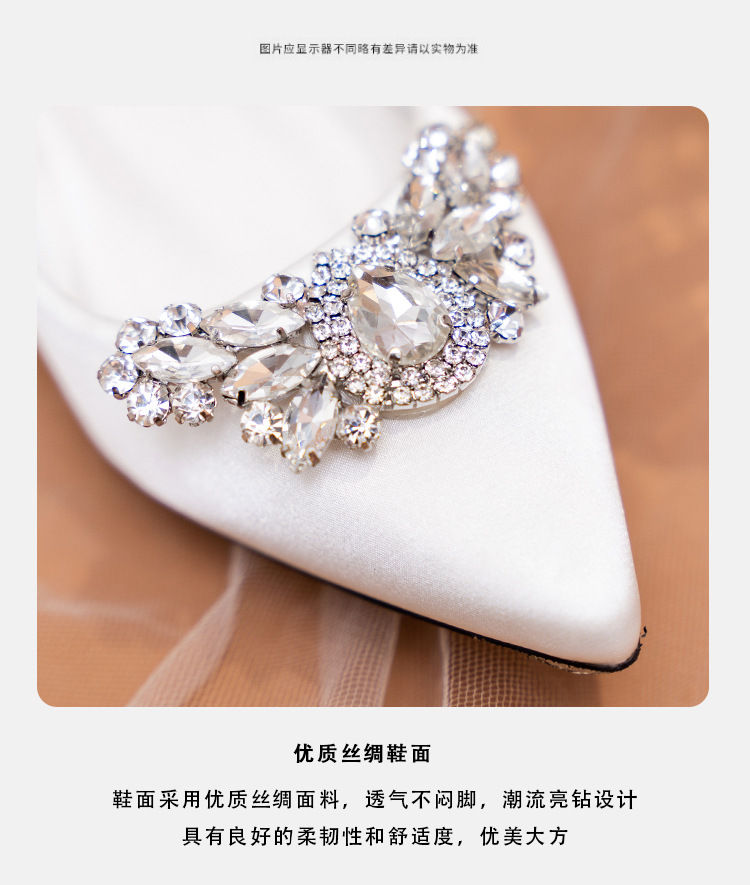 Thumbnail: Close-up of white pointed toe bridal shoe with rhinestone brooch.