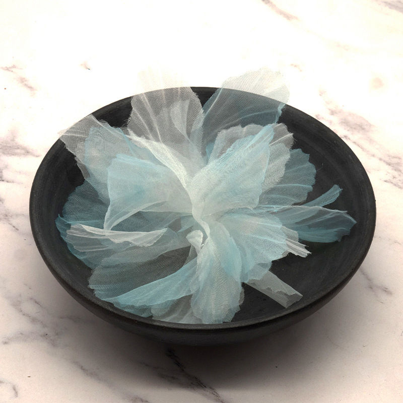 Thumbnail: Light blue organza simulated flower head in a black bowl