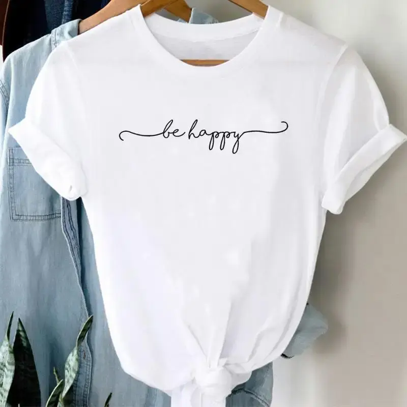White t-shirt with script text reading "be happy", tied front, folded sleeves.