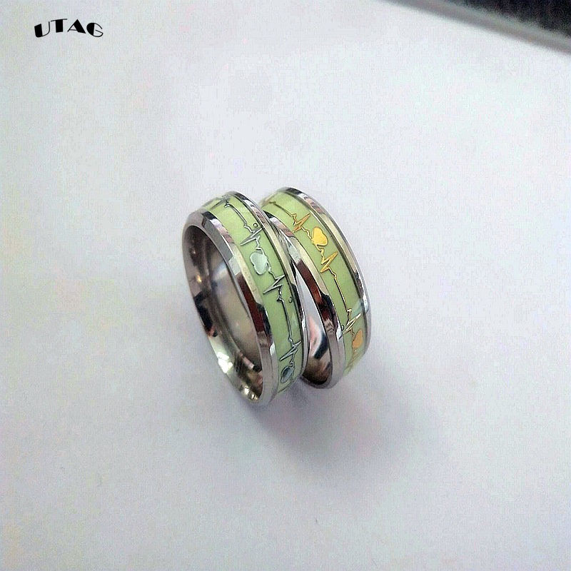 Thumbnail: Luminous stainless steel heart rings glowing in the dark.