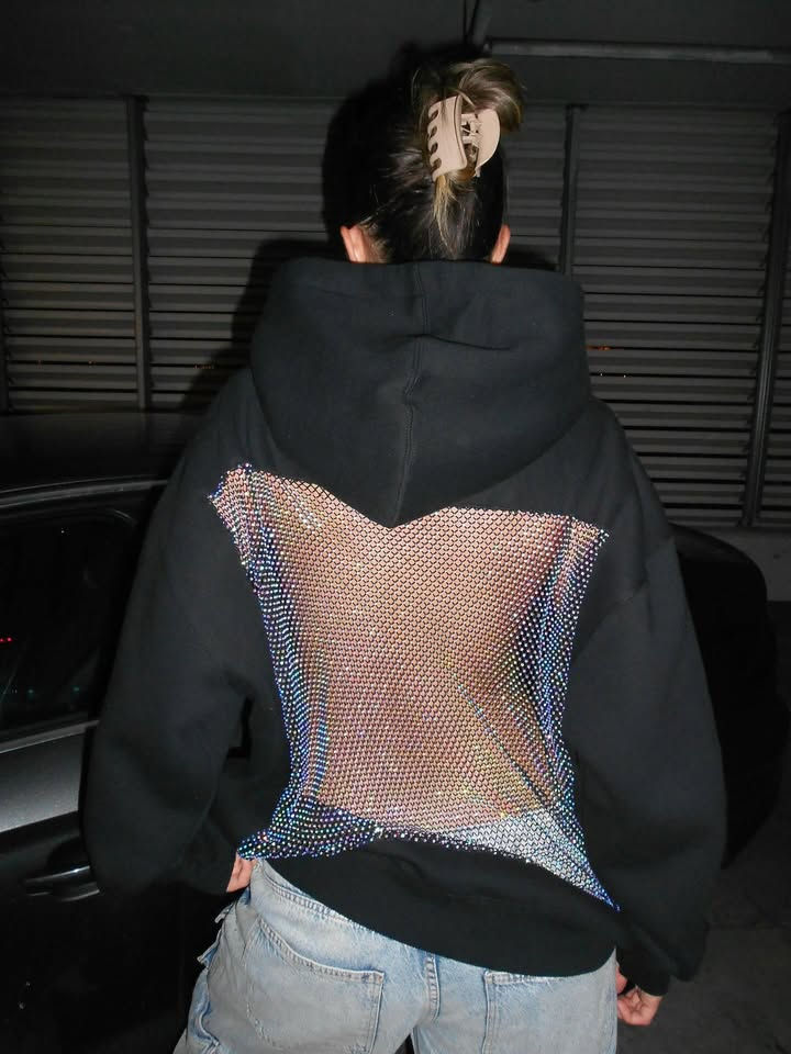 Thumbnail: Back view of a black hoodie with rhinestone mesh panel.