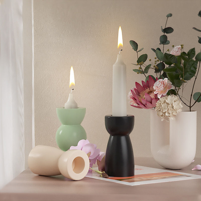 Thumbnail: Geometric concrete candle holders with lit taper candles
