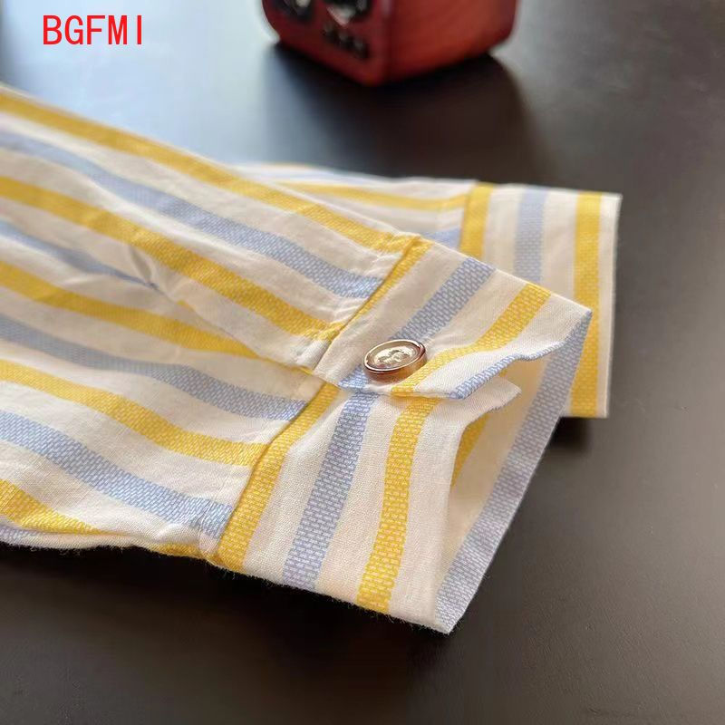 Thumbnail: Close-up of a striped shirt sleeve with a button cuff.