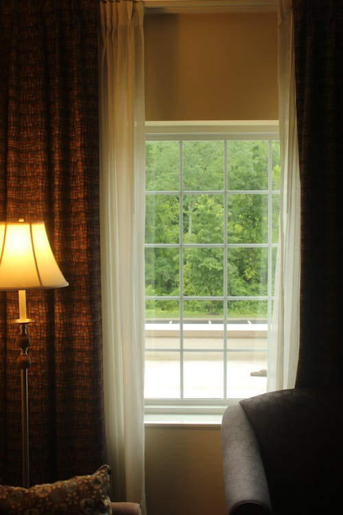 A warm lamp by a window in a cozy home interior — the glow of a home that is cared for.