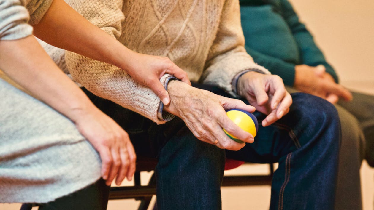 Two hands held together gently — a quiet moment of connection and care.