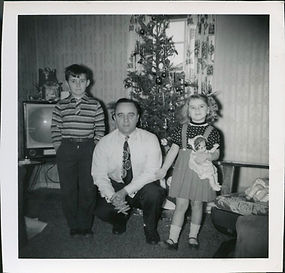 Family poses in front of TV and Christmas tree, 1956.