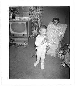 Pregnant? mother and son hang out in TV space, 1954