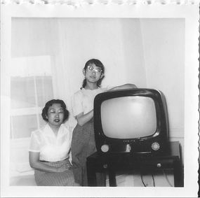 Woman (mother) and girl (daughter) pose with TV, 1954.