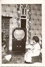 Two kids in pajamas watching early TV set, 1954.