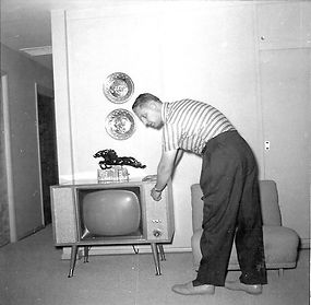 Man demonstrates TV set, Circa 1956-59.