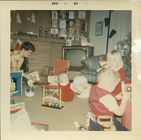Children play with Christmas gifts in front of TV, 1965.