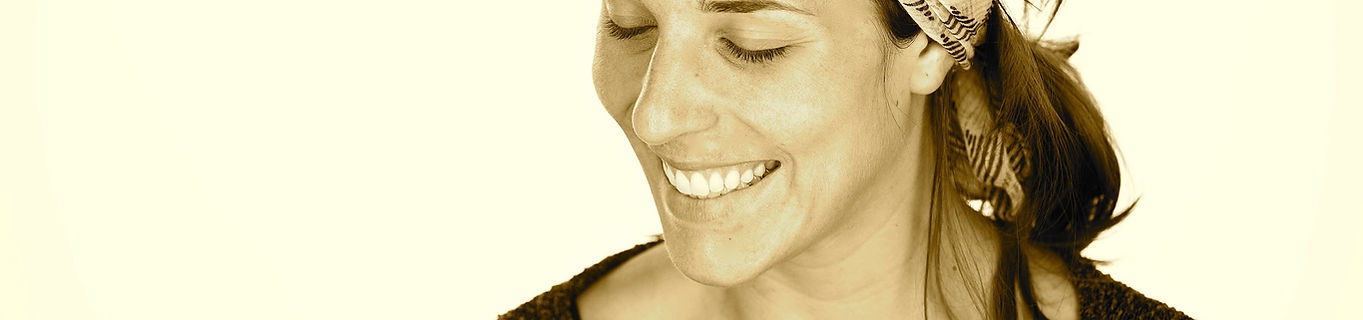 Photo of Amy's face smiling and looking down.