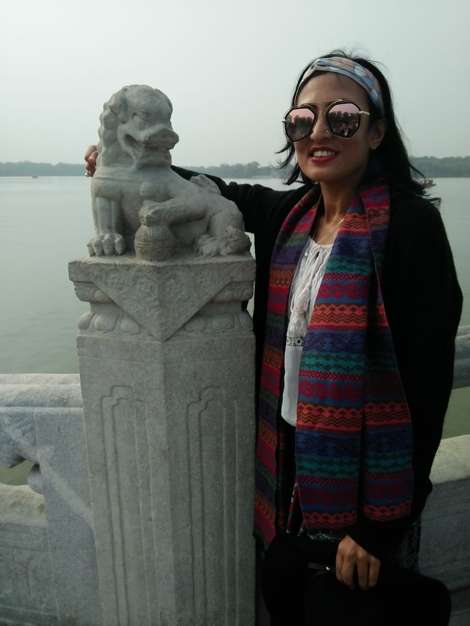 Me standing with a dragon statue in China's Imperial Palace