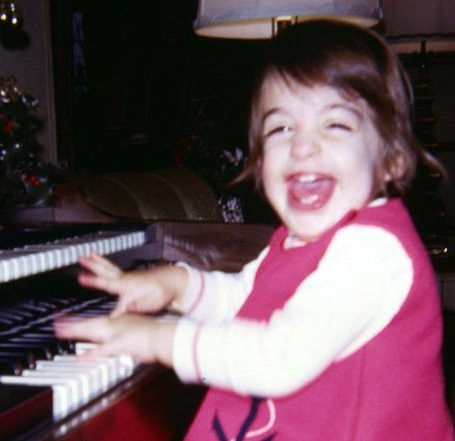 Traci Kanaan playing the organ at the age of 2