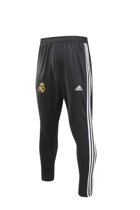Thumbnail: Black Real Madrid training pants with white stripes.