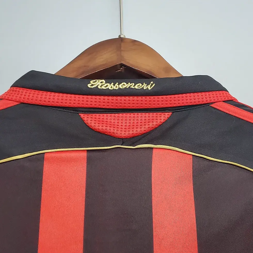Thumbnail: Back collar of a red and black striped AC Milan jersey with Rossoneri text