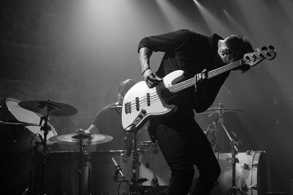 Black & white photo of Ocean Districts bassist playing live