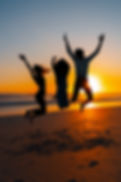 full-shot-silhouettes-people-jumping-sunset.jpg