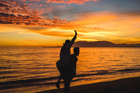 man-holding-woman-back-evening-sea-shore.jpg