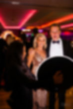 a couple at a wedding posing for a picture with the roaming photo booth 