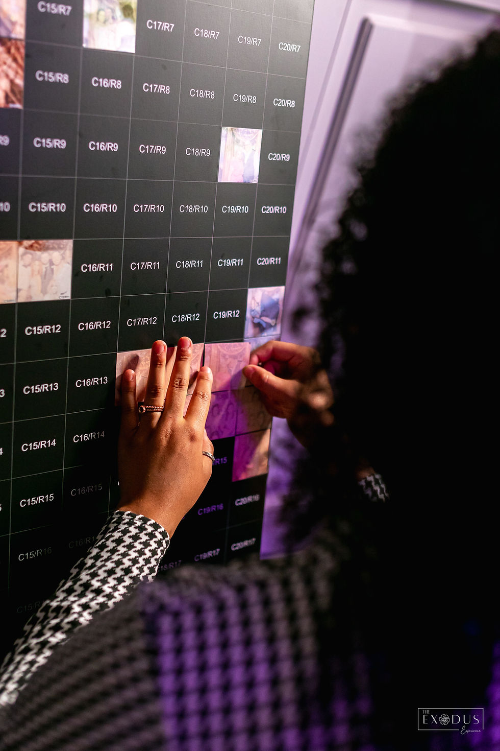 a woman adding a photo to a mosaic booth board.