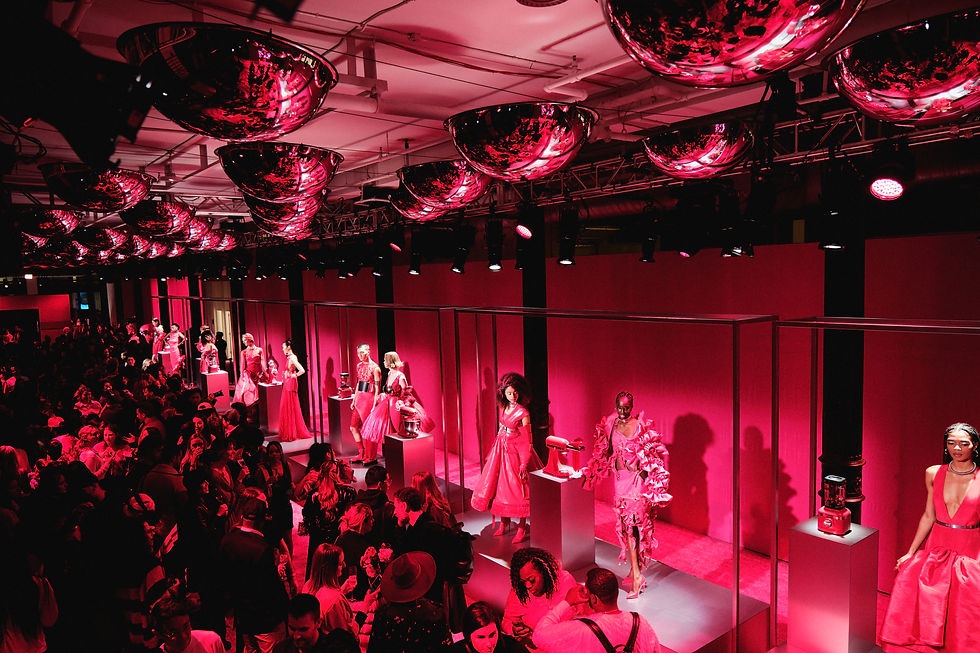Models showcase the vibrant KitchenAid Hibiscus collection at NYFW, set against striking hibiscus-pink backdrops.