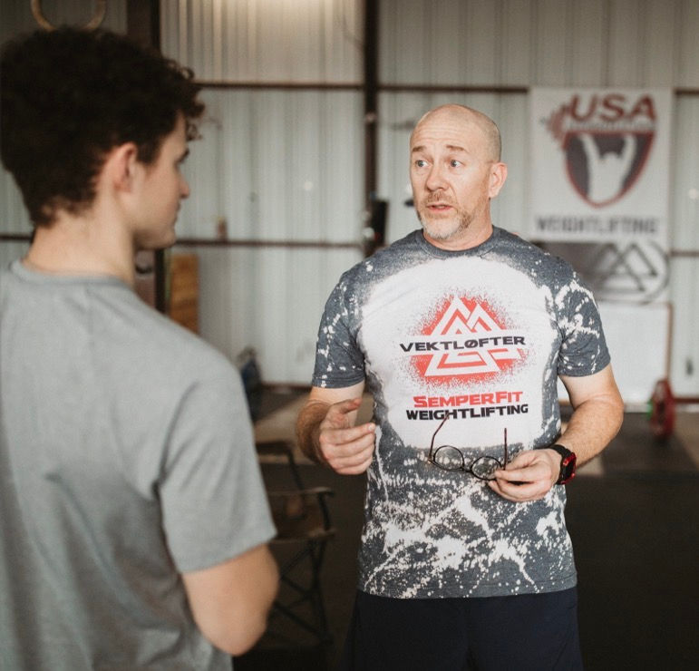 Close-up view of a fitness coach writing a personalized workout plan