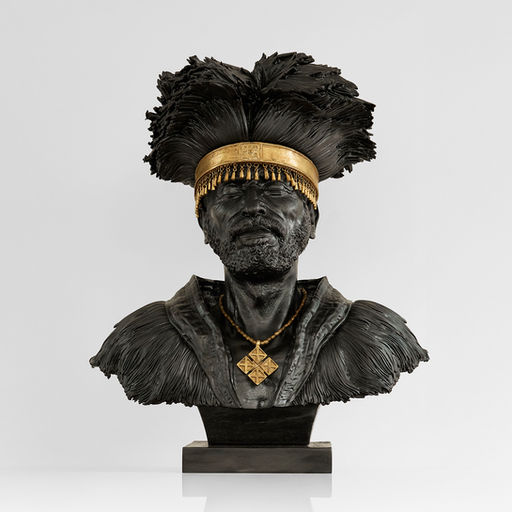 Yatreda, Zewed, 2026. Brass and nickel with non-fungible token of single-channel video, 57 × 45 × 29 cm, edition of 5 + 1 AP. Dark metal bust of a man with a feathered headdress and gold headband. Plan X Gallery